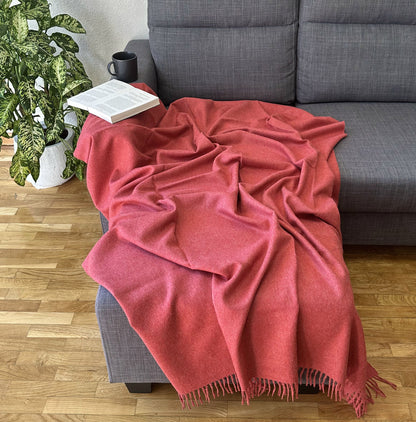 Solid red baby alpaca blanket, hand-finished. Measures 180 cm in length by 130 cm in width.