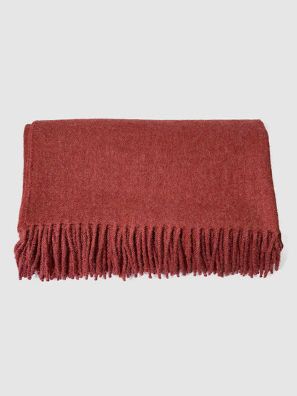 Solid red baby alpaca blanket, hand-finished. Measures 180 cm in length by 130 cm in width.