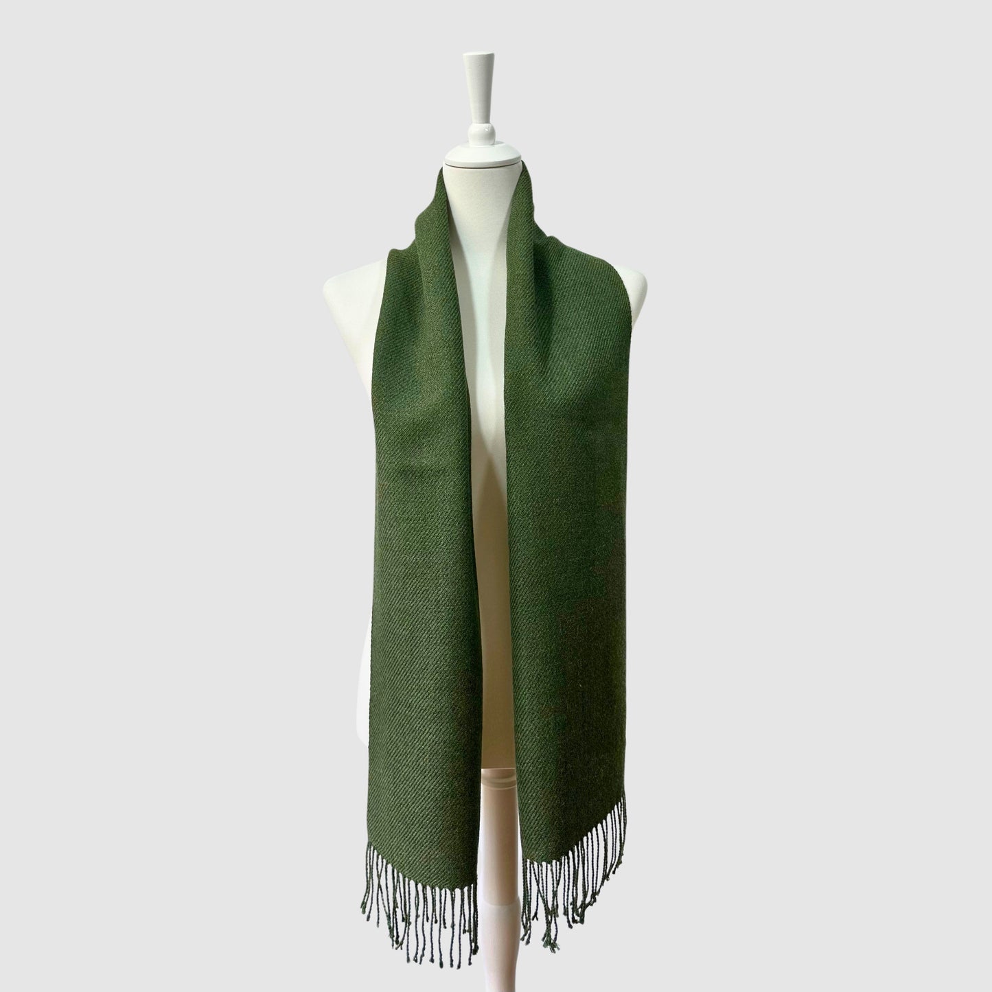 Hand-knitted solid green baby alpaca scarf. Measures 180 cm in length by 30 cm in width.