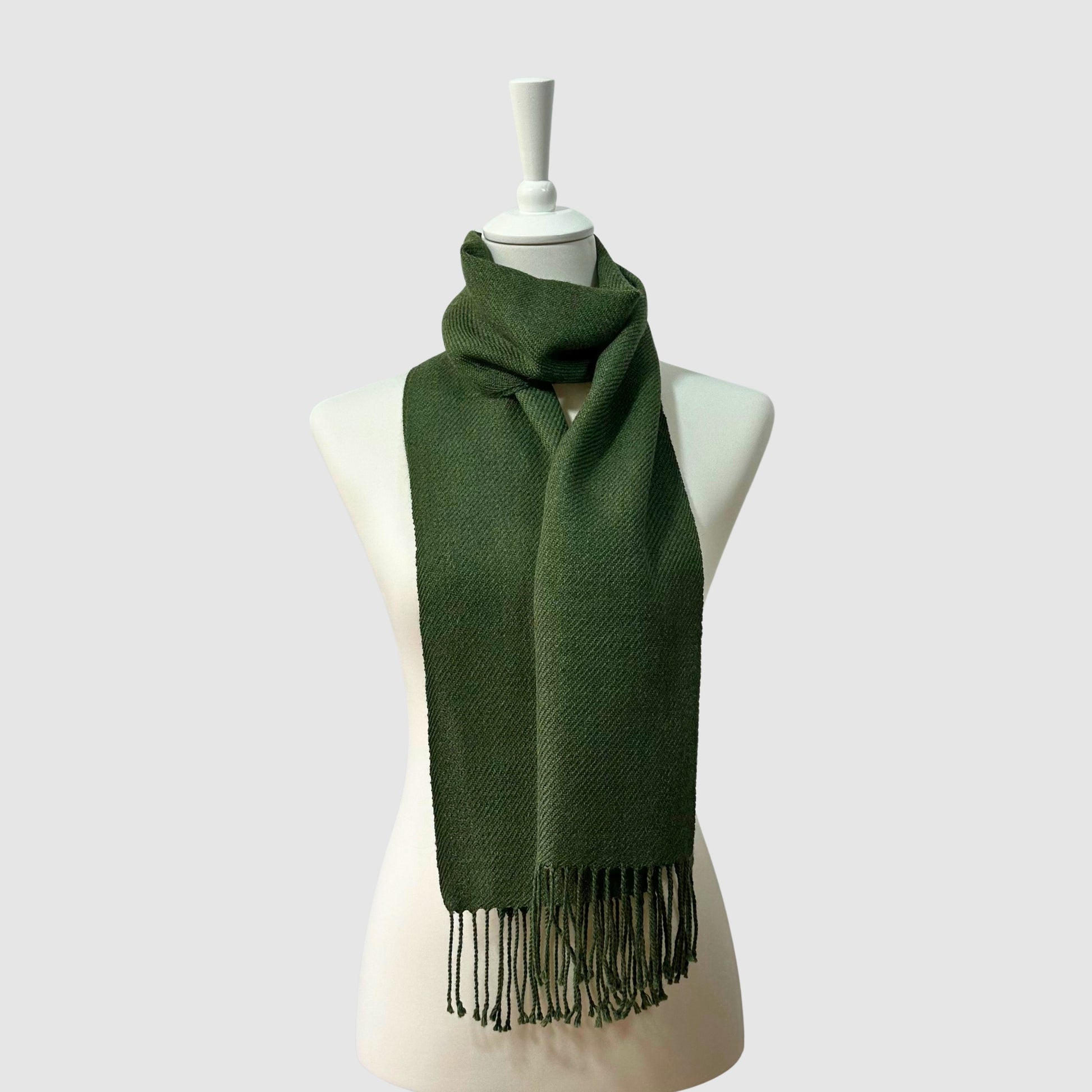 Hand-knitted solid green baby alpaca scarf. Measures 180 cm in length by 30 cm in width.