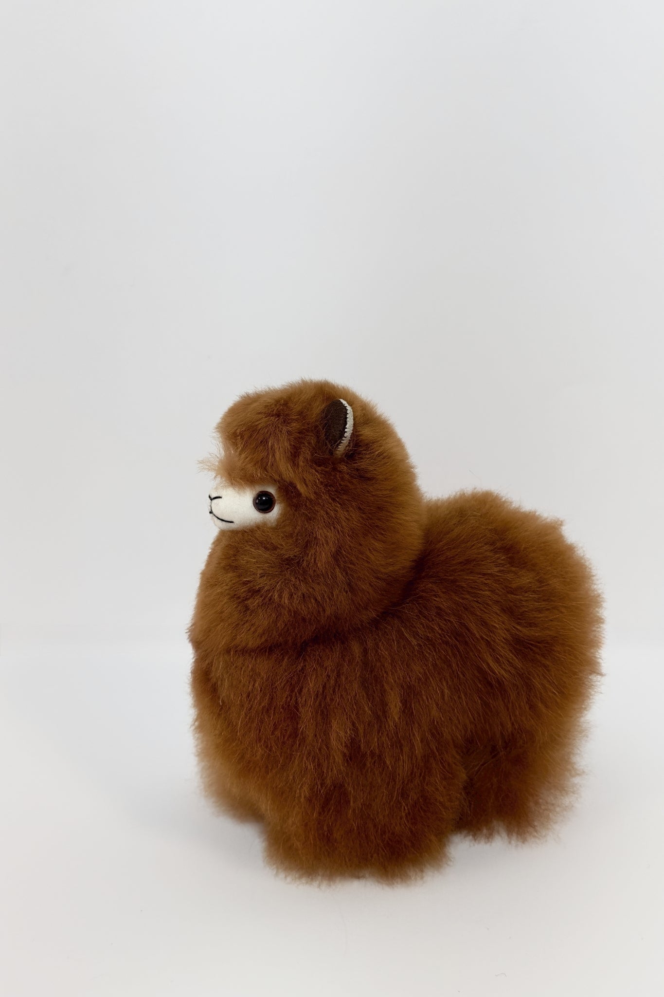 Adorable brown alpaca plush, perfect stuffed animal for gifting or cuddling.