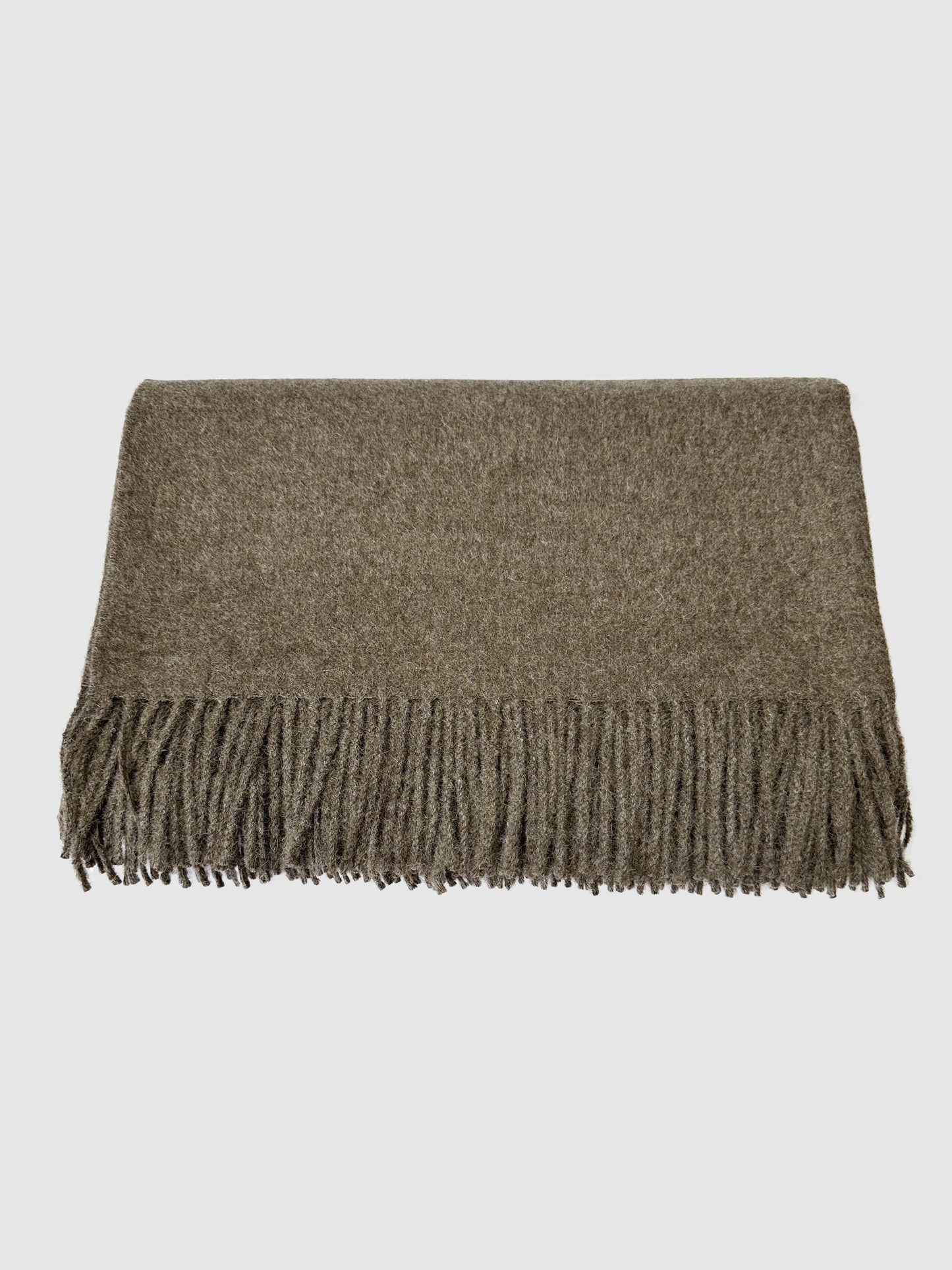 Cozy dark brown alpaca blanket for sofa and bed, perfect warm and stylish winter blanket for home comfort.